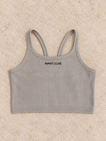 Mushroom ribbed Avant Luxe crop tank with small centered logo on warm stone